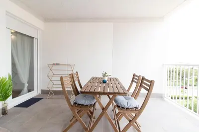 a wooden table and chairs in a living room at Global Vacacional, Apartamento nuevo en la playa de Canet d'en Berenguer in Canet de Berenguer