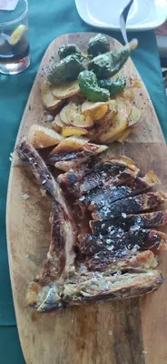 a cutting board with meat and vegetables on a table at Cozy Apartment close to the beach in beatiful area in El Perelló