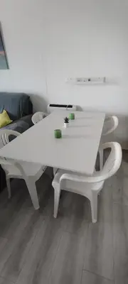 a white table and chairs in a living room at Primera línea en Cullera con piscina. Inmejorables vistas in Cullera