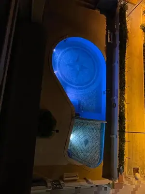a blue clock on the side of a building at Primera línea en Cullera con piscina. Inmejorables vistas in Cullera