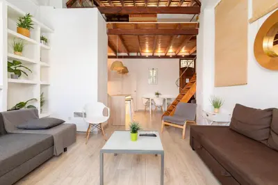 a living room with a couch and a table at Barón Suites Ruzafa in Valencia