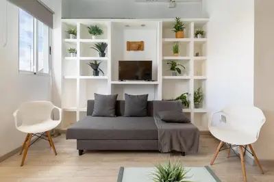 a living room with a couch and two chairs at Barón Suites Ruzafa in Valencia