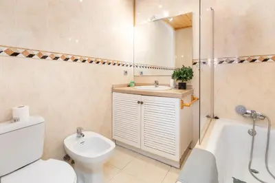 a bathroom with a toilet and a sink and a shower at Barón Suites Ruzafa in Valencia