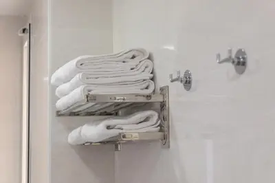 a bunch of towels on a rack in a bathroom at Reinapart Valencia Beach in Valencia