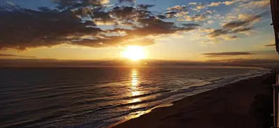 a sunset on the beach with the sun setting at BLUE DOUBLE PRIVATE ROOM AT FRONT BEACH - HABITACION en la playa piso compartido in Valencia