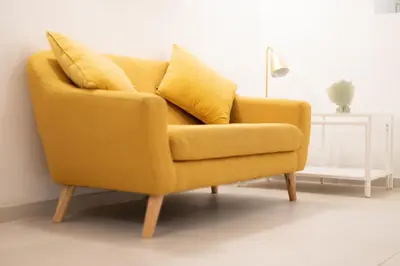 a yellow couch in a living room with a lamp at Cabanyal old fisherman's house in Valencia