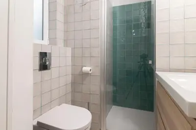 a bathroom with a shower and a toilet and a sink at Cabanyal old fisherman's house in Valencia