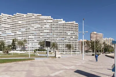 a large white building with palm trees in front of it at Florazar 1, II-A 11-B in Cullera