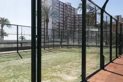 a tennis court seen through a window at Florazar 1, II-A 11-B in Cullera