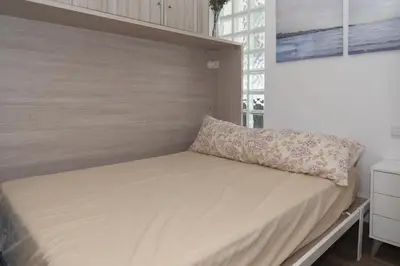 a bed in a room with a pillow on it at Florazar 1, II-A 11-B in Cullera