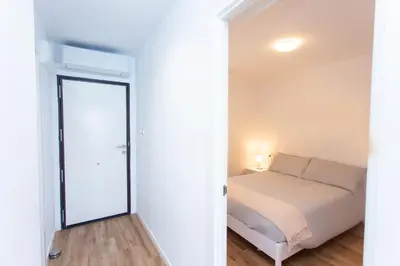 a bedroom with a bed and a mirror at Cullera Panoramic Sea Views Apartment in Cullera