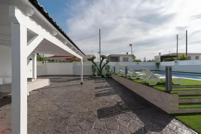 a patio with lounge chairs and a swimming pool at DREAM HOUSE in Burriana