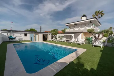 a villa with a swimming pool in front of a house at DREAM HOUSE in Burriana