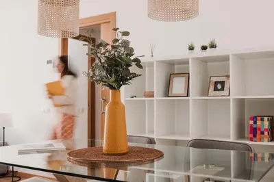 a vase sitting on a glass table in a room at Patacona Beach Apartment in Alboraya