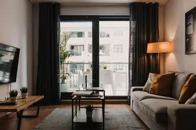 a living room with a couch and a large window at Patacona Beach Apartment in Alboraya