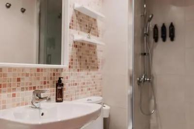 a bathroom with a sink and a toilet and a shower at Patacona Beach Apartment in Alboraya