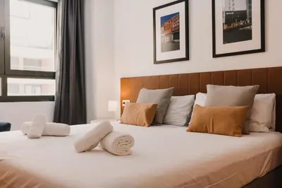 a bedroom with a large white bed with two pillows at Patacona Beach Apartment in Alboraya