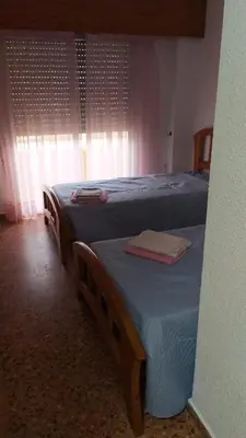 two twin beds in a room with a window at Florazar 2 Cullera in Cullera
