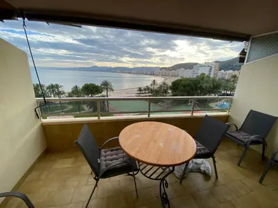a balcony with a table and chairs and a view of the ocean at Florazar 2 Cullera in Cullera