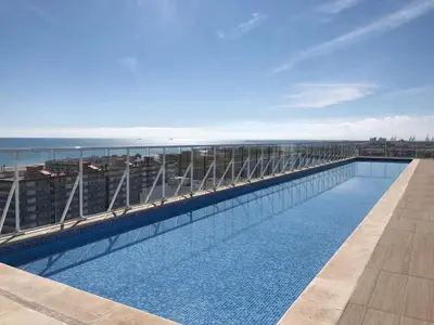 a swimming pool on the roof of a building at Global Vacacional, Apartamento con vistas al mar, Canet d'en Berenguer in Canet de Berenguer