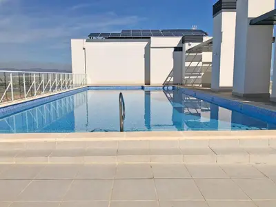 a swimming pool on the roof of a building at Global Vacacional, Apartamento con vistas al mar, Canet d'en Berenguer in Canet de Berenguer
