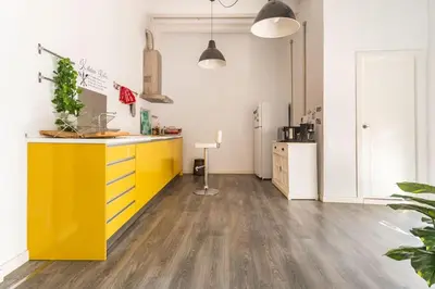 a kitchen with a yellow island in a room at 120 sqm Loft-style Apartment Beach Royal Marina in Valencia