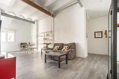 a living room with a couch and a table at 120 sqm Loft-style Apartment Beach Royal Marina in Valencia