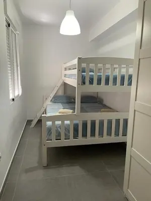 two bunk beds in a room with a window at UIM Mediterraneo Alicante Wifi in Puerto de Sagunto