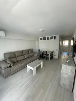 a living room with a couch and a table at Precioso apartamento de lujo en cullera in Cullera