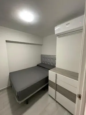 a small room with a bed and a cabinet at Precioso apartamento de lujo en cullera in Cullera