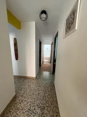 a hallway with white walls and a clock on the ceiling at Casa Rural Matilde in Caudiel