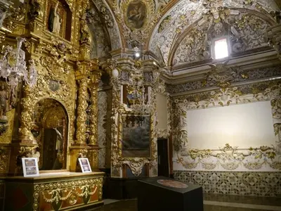 an ornate room with a table and a large wall at Casa Rural Matilde in Caudiel
