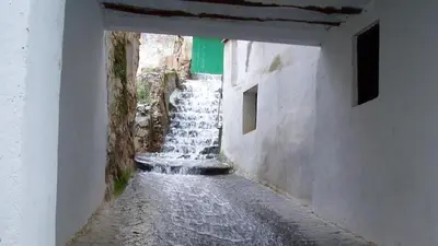 an alley with a waterfall in the middle of a building at Casa Rural Matilde in Caudiel