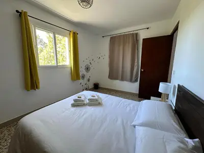 a bedroom with a bed with two towels on it at Casa Rural Matilde in Caudiel