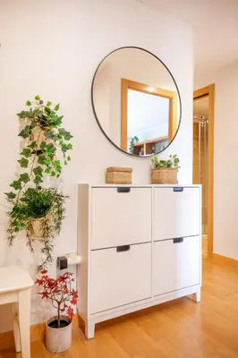 a white dresser in a room with a mirror at Luxotica Gardens Valencia in Valencia