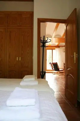 a bedroom with a bed and a room with a chair at Apartamentos La Muela - Chulilla in Chulilla
