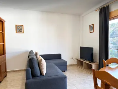 a living room with a couch and a tv at Apartamentos La Muela - Chulilla in Chulilla