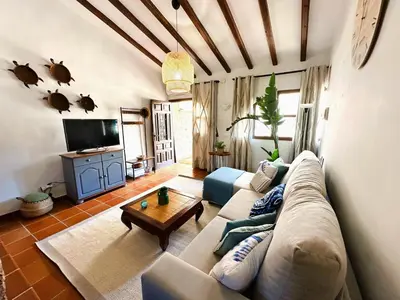 a living room with a couch and a table at MASÍA de SAN JUAN CASA NÚMERO 15 en Castillo con piscina, Aire Acondicionado y terraza privada in Segorbe