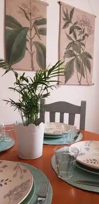 a table with plates and a potted plant on it at MASÍA de SAN JUAN CASA NÚMERO 1 en Castillo con piscina y Aire Acondicionado in Segorbe