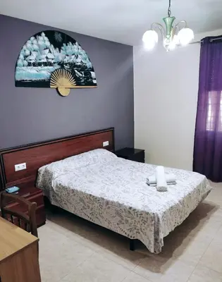 a bedroom with a bed and a clock on the wall at Habitación CID in Valencia