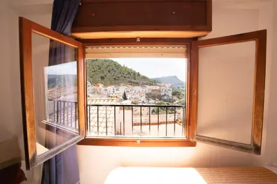 a window with a view of a city at House Los Angeles in Chulilla