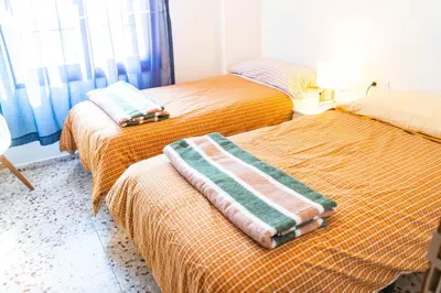two beds with towels on them in a room at House Los Angeles in Chulilla