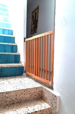 a set of stairs with a wooden gate in a building at House Los Angeles in Chulilla