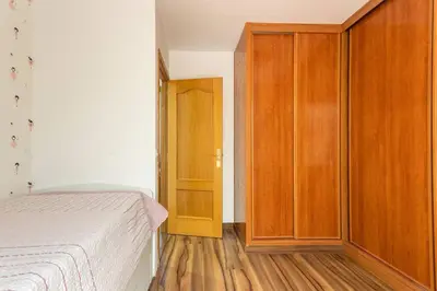 a bedroom with a bed and a wooden cabinet at Precioso piso in Catarroja