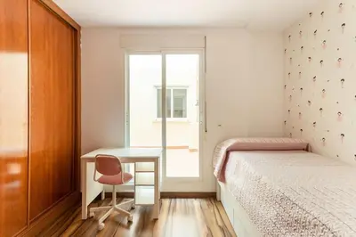 a bedroom with a desk and a bed and a window at Precioso piso in Catarroja