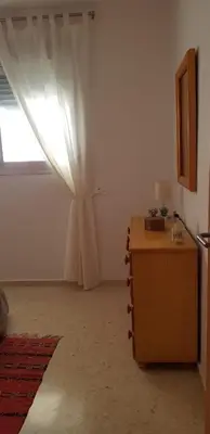 a room with a dresser and a window with a curtain at Apartamento C2 1Dormitorio in Lliria