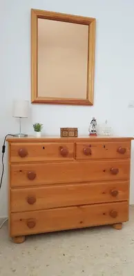 a wooden dresser with a mirror on top of it at Apartamento C2 1Dormitorio in Lliria