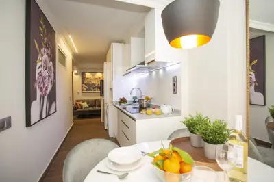 a kitchen and dining room with a table and chairs at SingularStays Xativa III in Valencia