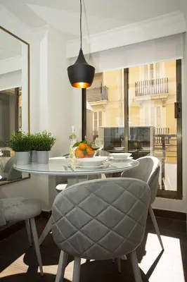a dining room with a table and chairs and a window at SingularStays Xativa III in Valencia