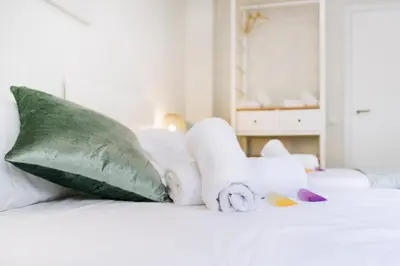 a bed with stuffed animals and pillows on it at Cabanyal Luxury Malvarrosa Beach in Valencia